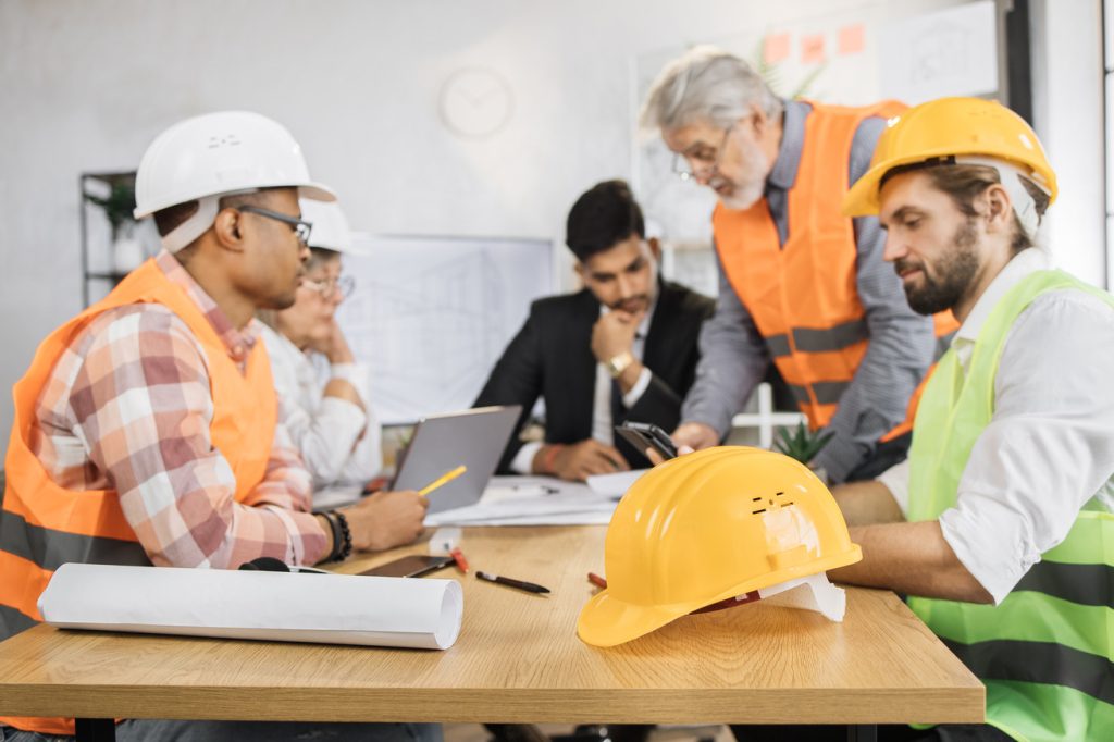 Group of men in hardhats at a meeting
